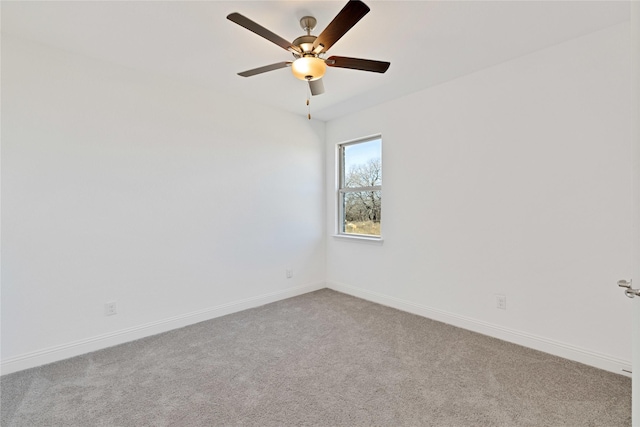 empty room with ceiling fan, baseboards, and carpet flooring