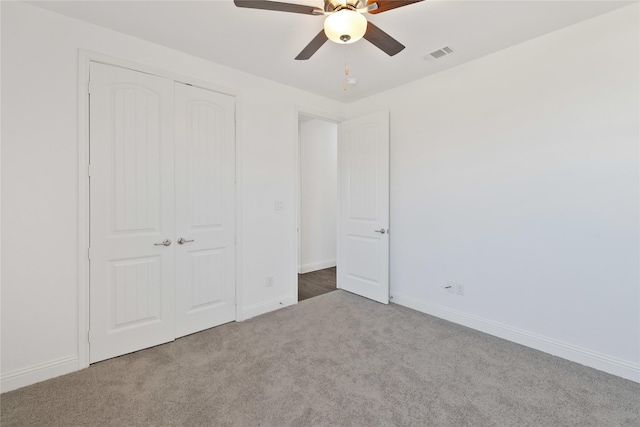 unfurnished bedroom with carpet, baseboards, and a closet