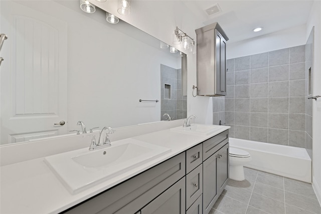 full bath with double vanity, visible vents, toilet, a sink, and tile patterned flooring