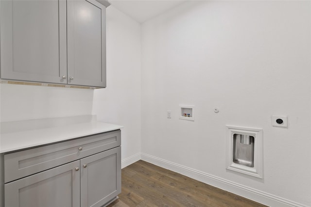 laundry room with cabinet space, dark wood finished floors, gas dryer hookup, washer hookup, and electric dryer hookup