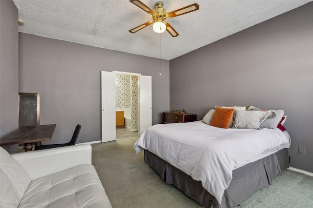 carpeted bedroom with baseboards, a ceiling fan, a textured ceiling, and ensuite bathroom