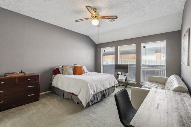 bedroom with lofted ceiling, visible vents, a textured ceiling, and carpet flooring