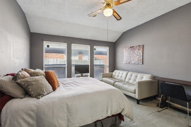 bedroom featuring lofted ceiling, carpet, a textured ceiling, and a textured wall