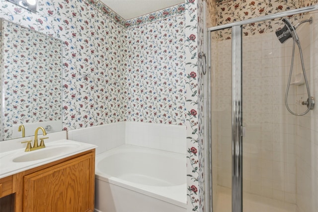 bathroom with a stall shower, vanity, a bath, and wallpapered walls