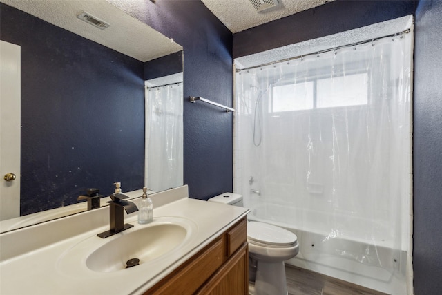 bathroom featuring a textured ceiling, visible vents, vanity, and toilet