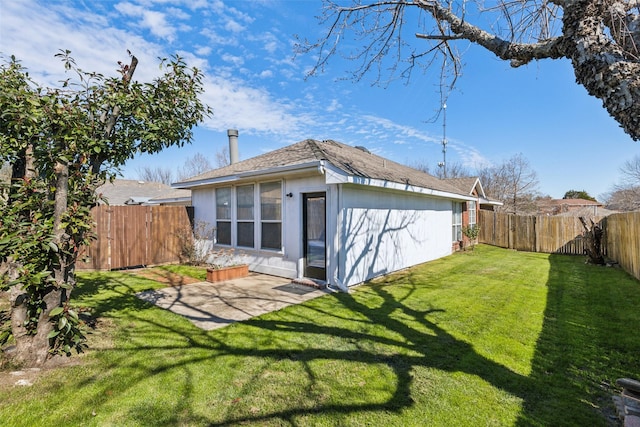 back of property with a lawn, a patio area, and a fenced backyard