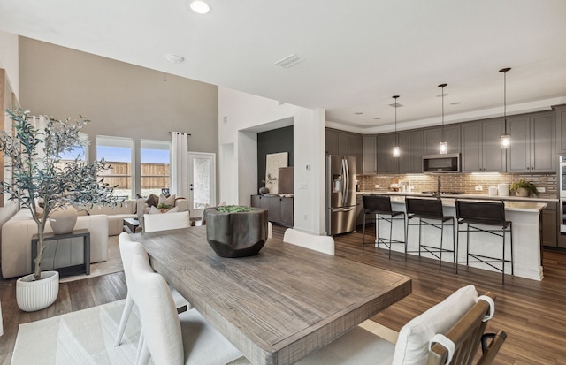 dining area with dark wood-style floors, visible vents, and recessed lighting