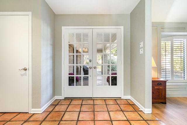 entryway with french doors and baseboards