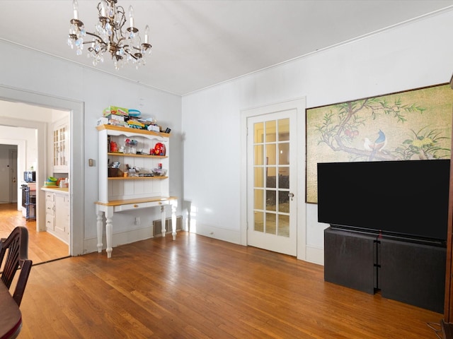 unfurnished living room featuring a chandelier and light wood finished floors