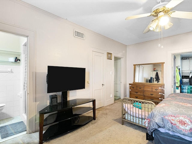 bedroom featuring visible vents, ornamental molding, ensuite bathroom, carpet, and a closet