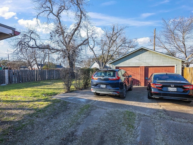 view of home's exterior with fence, a lawn, and an outdoor structure