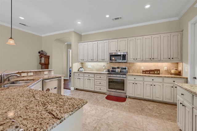 418 Navajo Trl, Gainesville, TX 76240 - kitchen featuring appliances with stainless steel finishes, arched walkways, visible vents, and a sink