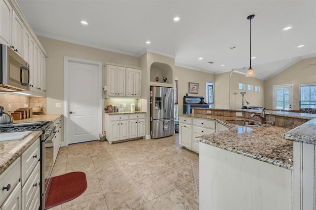 418 Navajo Trl, Gainesville, TX 76240 - kitchen featuring light stone counters, crown molding, stainless steel appliances, lofted ceiling, and a sink