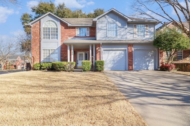 traditional-style house featuring concrete driveway, brick siding, a front lawn, and an attached garage