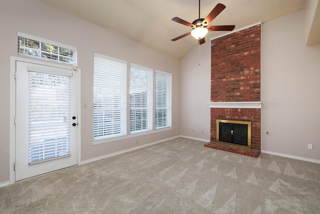 unfurnished living room with carpet floors, a fireplace, a wealth of natural light, and lofted ceiling