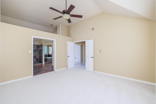 unfurnished bedroom featuring light carpet, high vaulted ceiling, visible vents, and baseboards