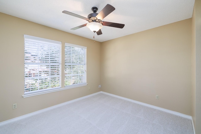 unfurnished room with ceiling fan, baseboards, and light colored carpet