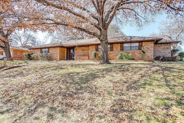 single story home featuring brick siding