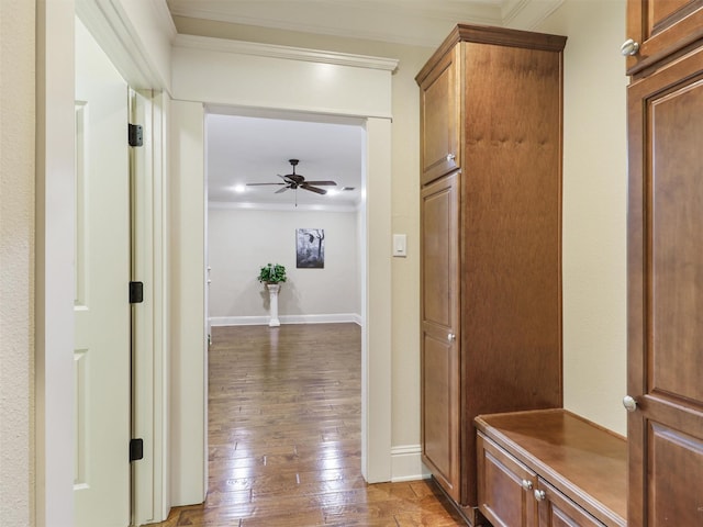 hall featuring ornamental molding, baseboards, and hardwood / wood-style flooring