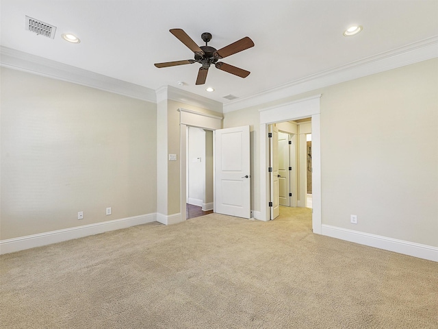 unfurnished bedroom featuring light carpet, baseboards, visible vents, and ornamental molding