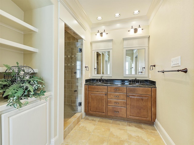 bathroom featuring crown molding, a sink, a shower stall, and double vanity