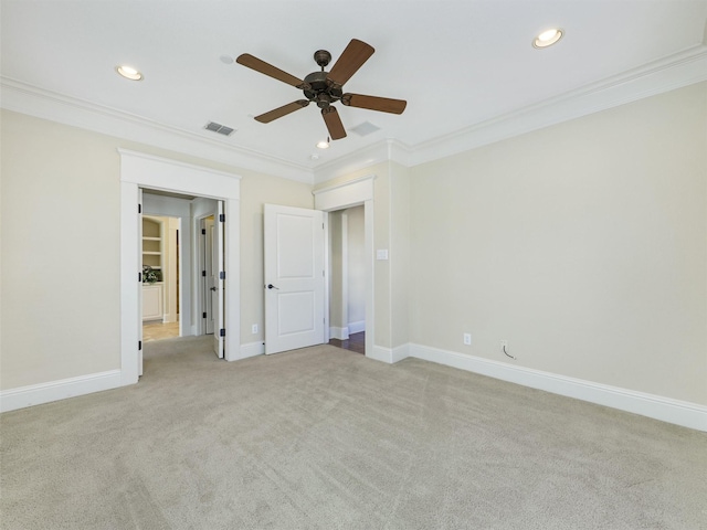 unfurnished bedroom with ornamental molding, visible vents, and light colored carpet