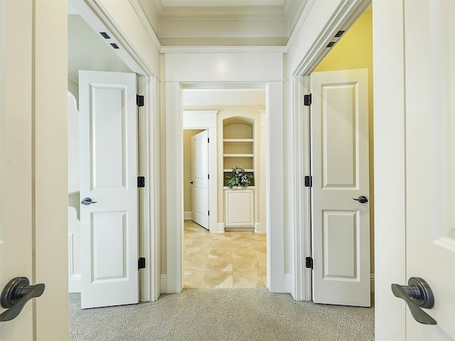 hallway featuring ornamental molding and light colored carpet