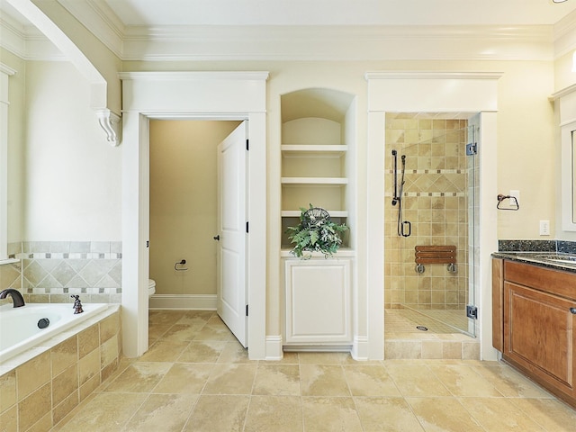 bathroom featuring built in features, crown molding, a shower stall, and toilet