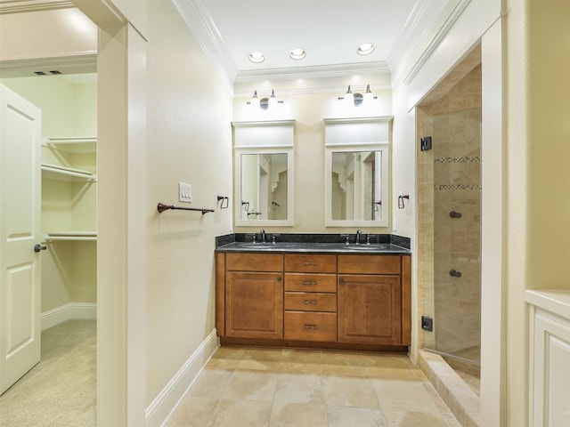 bathroom featuring ornamental molding, a sink, a shower stall, and double vanity