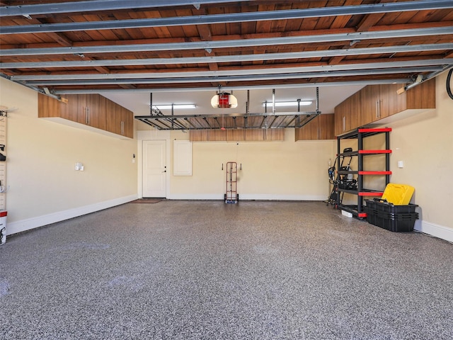 garage featuring baseboards and a garage door opener