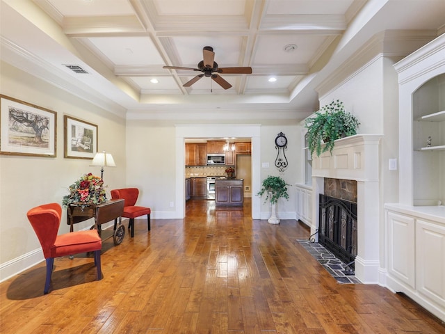 living area featuring dark wood-style floors, visible vents, coffered ceiling, and a tile fireplace