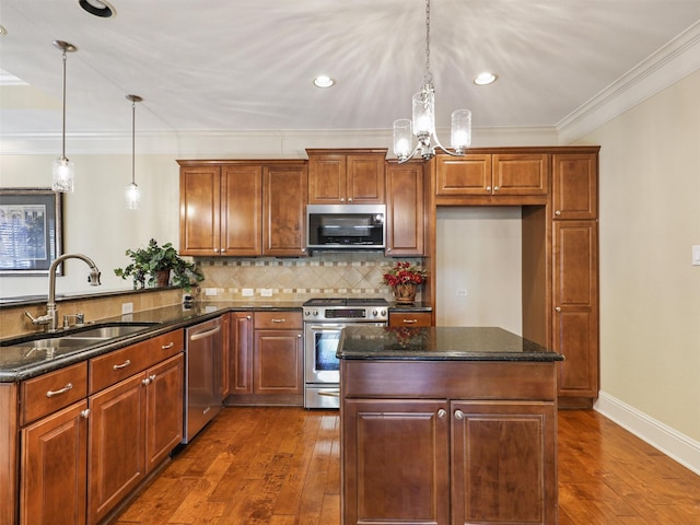 kitchen with tasteful backsplash, appliances with stainless steel finishes, dark wood-style flooring, a peninsula, and a sink