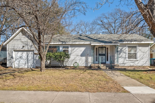 ranch-style house with a garage and a front lawn