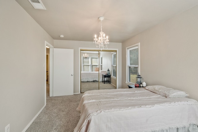 carpeted bedroom featuring baseboards, visible vents, a chandelier, and a closet