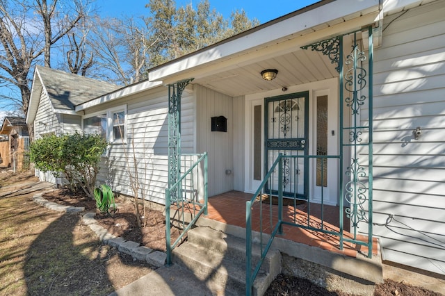 view of exterior entry featuring covered porch