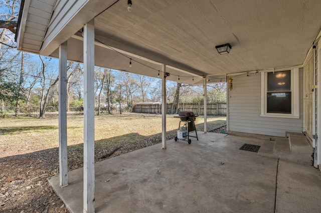 view of patio featuring fence