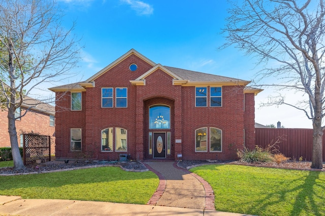 view of front of home with fence, a front lawn, and brick siding