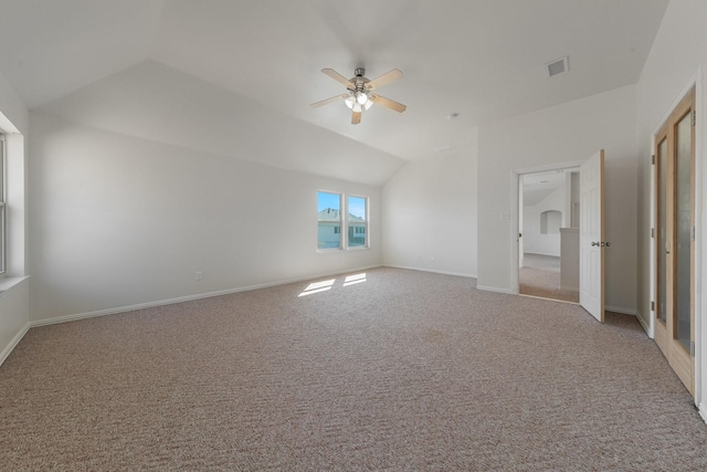 unfurnished bedroom featuring visible vents, baseboards, ceiling fan, carpet, and vaulted ceiling