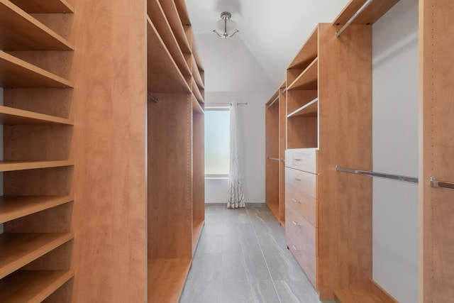 spacious closet featuring vaulted ceiling