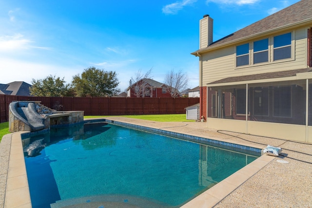 view of pool featuring a sunroom, a fenced backyard, a fenced in pool, and a water slide