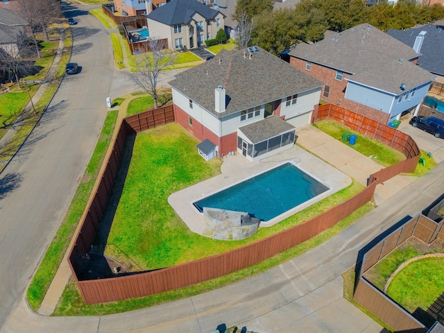 view of swimming pool with a fenced in pool, a residential view, a fenced backyard, and a patio