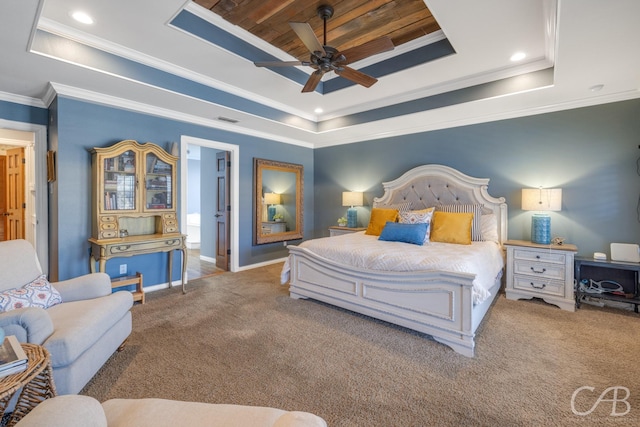 bedroom with ornamental molding, carpet floors, a tray ceiling, and visible vents