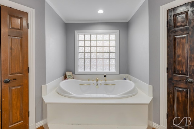 bathroom with ornamental molding and a bath