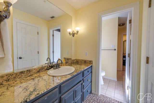 bathroom featuring toilet, visible vents, baseboards, vanity, and tile patterned floors