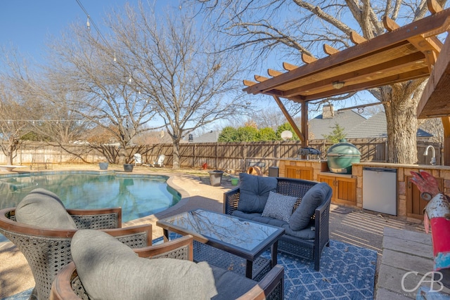 view of patio / terrace with an outdoor kitchen, a fenced backyard, outdoor lounge area, a sink, and a fenced in pool