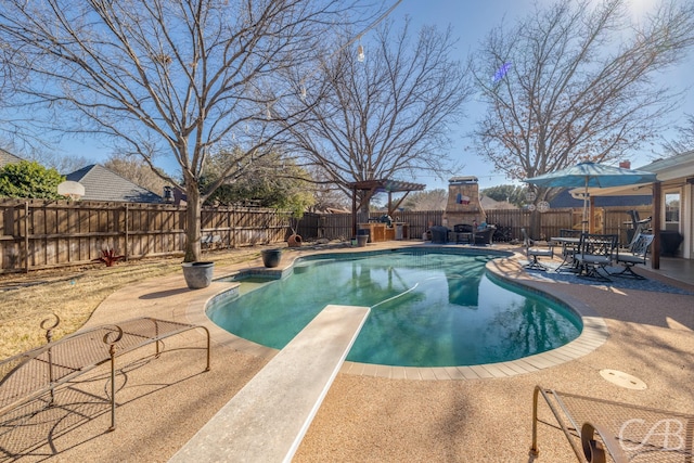 view of pool featuring a diving board, a patio area, a fenced backyard, and a fenced in pool