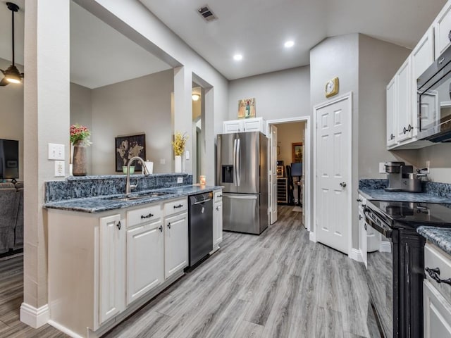 kitchen with black appliances, light wood finished floors, visible vents, and white cabinets