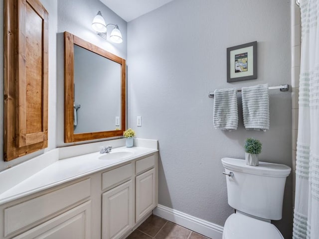 full bathroom featuring tile patterned flooring, baseboards, vanity, and toilet