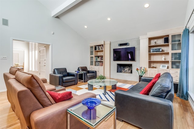 living area featuring visible vents, light wood-type flooring, a fireplace, beam ceiling, and recessed lighting