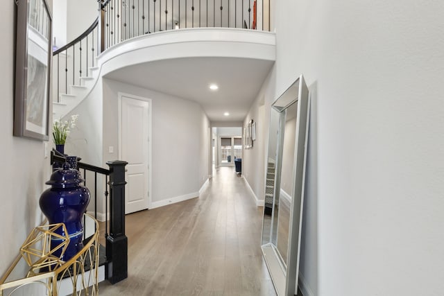 1600 Pebblebrook Ln, Prosper, TX 75078 - hallway with baseboards, recessed lighting, stairway, a high ceiling, and wood finished floors